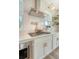Modern kitchen with stainless steel appliances, white cabinets, and a pot filler faucet at 142 Midtown Ave, Summerville, SC 29486