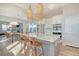 Open-concept kitchen with large island, seating, stainless steel appliances, and pendant lighting showcasing the modern design at 142 Midtown Ave, Summerville, SC 29486
