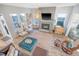 Open living room featuring a fireplace, stylish seating, and abundant natural light at 142 Midtown Ave, Summerville, SC 29486