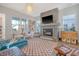Spacious living room with modern fireplace, ample seating, and large windows at 142 Midtown Ave, Summerville, SC 29486