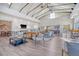Spacious resident's lounge with soaring ceilings, wood floors, fireplace, tv, and an abundance of seating at 142 Midtown Ave, Summerville, SC 29486