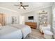 Spacious main bedroom with hardwood floors, ceiling fan, and a cozy seating area for relaxation at 142 Midtown Ave, Summerville, SC 29486