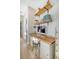 Charming office space with a natural wood desk, floating shelves, and stylish decor in a bright, hallway setting at 142 Midtown Ave, Summerville, SC 29486