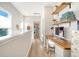 Hallway featuring a built-in office space with a desk, wooden shelves, and natural light from the nearby windows at 142 Midtown Ave, Summerville, SC 29486