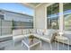 Inviting covered patio with a comfortable sectional sofa, coffee table, side table and a view of the backyard at 142 Midtown Ave, Summerville, SC 29486