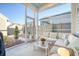 Relaxing screened porch features comfortable seating, stylish decor, and outdoor views, perfect for unwinding at 142 Midtown Ave, Summerville, SC 29486