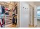 Bright walk-in closet with custom shelving, hanging racks, and clear storage bins for optimal organization at 142 Midtown Ave, Summerville, SC 29486