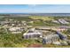 Aerial view of a coastal condominium community with a manicured golf course, highway, and ocean views at 155 Wingo Way # 421, Mount Pleasant, SC 29464