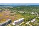 Aerial view of a coastal condominium community surrounded by lush trees with ocean views at 155 Wingo Way # 421, Mount Pleasant, SC 29464