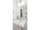 Bathroom featuring a pedestal sink, decorative mirror, and updated fixtures at 155 Wingo Way # 421, Mount Pleasant, SC 29464