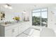Bright bathroom with white cabinets, marble counters, double sinks, and a large window with sunny views at 155 Wingo Way # 421, Mount Pleasant, SC 29464