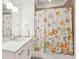 Bathroom with marble vanity and a shower with floral patterned shower curtain at 155 Wingo Way # 421, Mount Pleasant, SC 29464