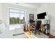 Sunlit bedroom with a wooden desk, computer and large window showing palm tree views at 155 Wingo Way # 421, Mount Pleasant, SC 29464