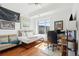 A brightly lit bedroom with a work space and daybed, and hardwood floors at 155 Wingo Way # 421, Mount Pleasant, SC 29464