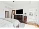Bright bedroom with a view to a bathroom and large dresser with a TV on it at 155 Wingo Way # 421, Mount Pleasant, SC 29464