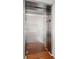 Modern stainless steel residential elevator with hardwood flooring at 155 Wingo Way # 421, Mount Pleasant, SC 29464
