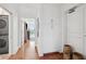 Bright hallway featuring hardwood floors, built-in cabinets, and laundry closet with a stacked washer and dryer at 155 Wingo Way # 421, Mount Pleasant, SC 29464