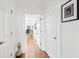 Hallway featuring hardwood floors, white walls, and doorways to various rooms in the home at 155 Wingo Way # 421, Mount Pleasant, SC 29464