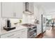 Bright kitchen features stainless steel appliances, marble countertops, and white cabinetry at 155 Wingo Way # 421, Mount Pleasant, SC 29464