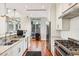 Bright kitchen features white cabinets, stainless steel appliances, and hardwood floors at 155 Wingo Way # 421, Mount Pleasant, SC 29464