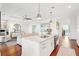 Open concept kitchen and living room area with hardwood floors and white accents at 155 Wingo Way # 421, Mount Pleasant, SC 29464