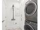 Modern laundry room features a stacked washer and dryer, along with a mounted vacuum cleaner at 155 Wingo Way # 421, Mount Pleasant, SC 29464