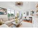 Open-concept living and dining area with hardwood floors, large windows, and stylish furnishings at 155 Wingo Way # 421, Mount Pleasant, SC 29464