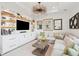 Elegant living room featuring custom built-ins, stylish chandelier, and comfortable sectional sofa at 155 Wingo Way # 421, Mount Pleasant, SC 29464