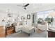 Bright living room with a ceiling fan, tile flooring, and sliding glass doors to balcony at 155 Wingo Way # 421, Mount Pleasant, SC 29464