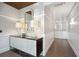 Hallway with decorative walls, tiled floors, statement lighting, and console table at 155 Wingo Way # 421, Mount Pleasant, SC 29464