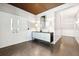 Hallway with decorative walls, tiled floors, statement lighting, and console table at 155 Wingo Way # 421, Mount Pleasant, SC 29464