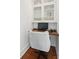 Bright office nook featuring built-in cabinets, a sleek desk, and polished wood floors at 155 Wingo Way # 421, Mount Pleasant, SC 29464