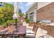Outdoor grilling area with multiple grills, prep areas, and dining tables shaded with large umbrellas at 155 Wingo Way # 421, Mount Pleasant, SC 29464