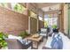 Inviting outdoor patio featuring comfortable seating, stylish decor, and a brick accent wall at 155 Wingo Way # 421, Mount Pleasant, SC 29464