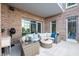 Enjoy this beautifully staged patio with brick accents, plush seating, and space for relaxation at 155 Wingo Way # 421, Mount Pleasant, SC 29464