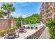 Beautiful pool area with tables and chairs offer residents an outdoor oasis for relaxation at 155 Wingo Way # 421, Mount Pleasant, SC 29464