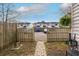 Backyard with a wooden fence and a brick path leading to a gate for privacy at 1662 Hunters Run Dr, Mount Pleasant, SC 29464