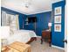 Charming bedroom with blue walls, a four-poster bed, and decorative artwork at 1662 Hunters Run Dr, Mount Pleasant, SC 29464
