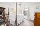 Comfortable primary bedroom featuring a four poster bed, ceiling fan and natural light at 1662 Hunters Run Dr, Mount Pleasant, SC 29464