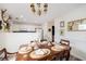 Dining room with table set for six, chandelier, and view to kitchen at 1662 Hunters Run Dr, Mount Pleasant, SC 29464