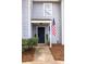 Inviting townhouse entrance featuring a dark door, potted plants, and American flag at 1662 Hunters Run Dr, Mount Pleasant, SC 29464