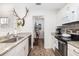 Bright kitchen with stainless steel appliances, granite counters and wooden floors at 1662 Hunters Run Dr, Mount Pleasant, SC 29464