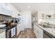 Bright kitchen with stainless steel appliances, granite counters and wooden floors at 1662 Hunters Run Dr, Mount Pleasant, SC 29464