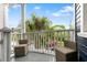 Inviting balcony featuring comfortable wicker chairs with a view of palm trees at 167 Spring St # A/B, Charleston, SC 29403