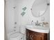 A clean bathroom featuring a wood vanity, decorative mirror and tiled shower at 167 Spring St # A/B, Charleston, SC 29403