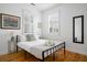 A well lit bedroom with stylish decor, featuring hardwood floors and natural light at 167 Spring St # A/B, Charleston, SC 29403
