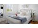 Bright bedroom featuring a comfortable bed with a striped throw blanket and ample natural light at 167 Spring St # A/B, Charleston, SC 29403