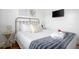 Bright bedroom featuring a comfortable bed with a striped throw blanket and mounted television at 167 Spring St # A/B, Charleston, SC 29403