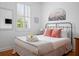 A cozy bedroom featuring a queen bed, large window, and ample natural light at 167 Spring St # A/B, Charleston, SC 29403