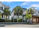 Charming two-story home featuring a small balcony, palm trees, and beautiful landscaping at 167 Spring St # A/B, Charleston, SC 29403
